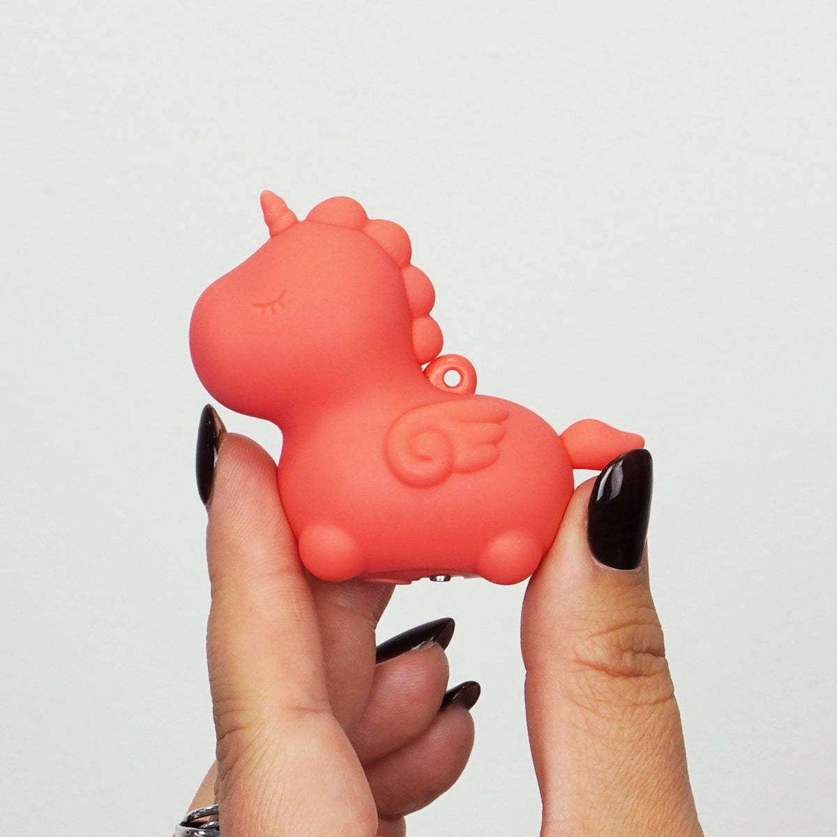 Hand holding the Unihorn Mini Peachy Pony