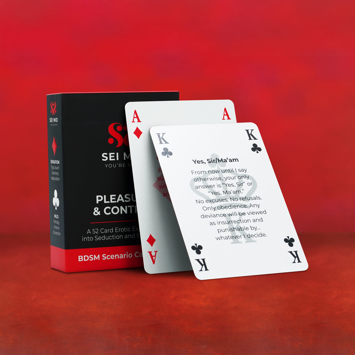 Pleasure & Control 52 card deck with sample scenario cards in front of the box on red