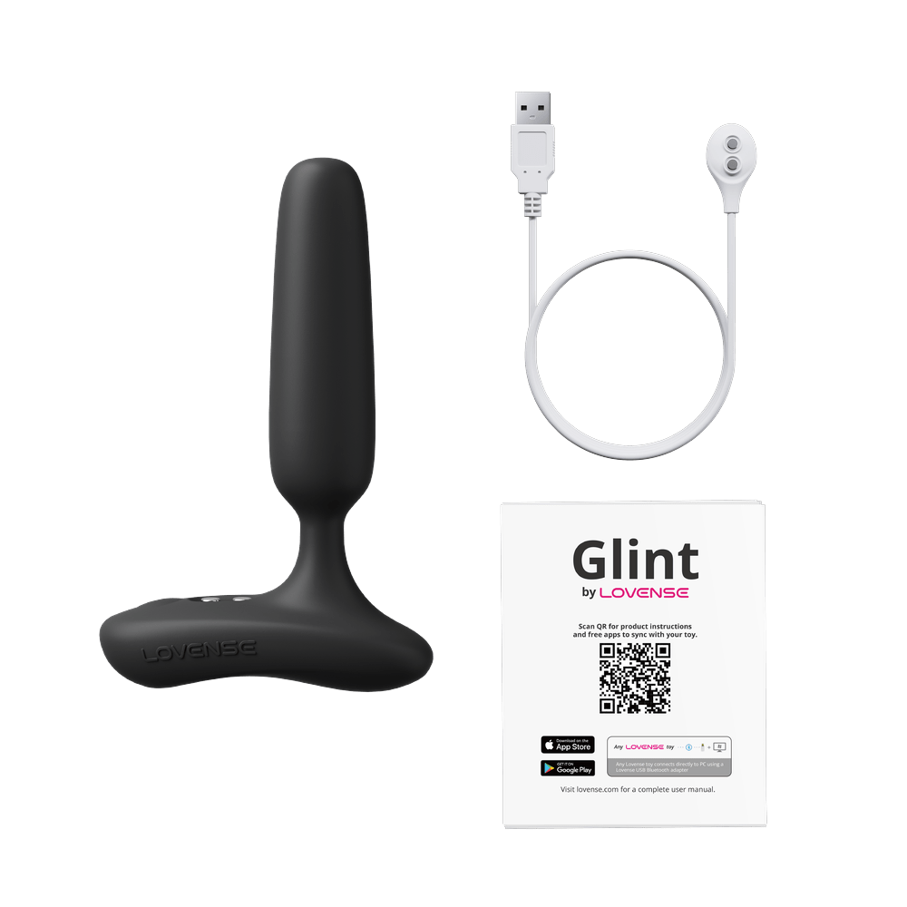 Lovense Glint box contents: black touch-responsive butt plug, magnetic USB charging cable and user manual