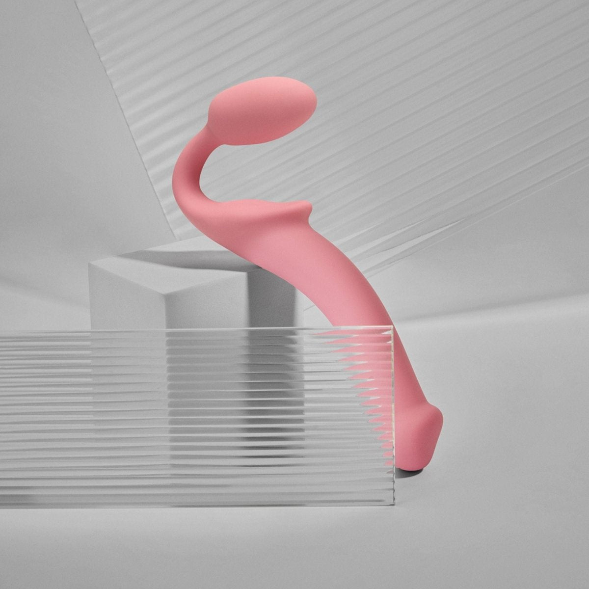 Strap On Me Bendable Strapless Strap-On in Pastel Pink, on a display plinth