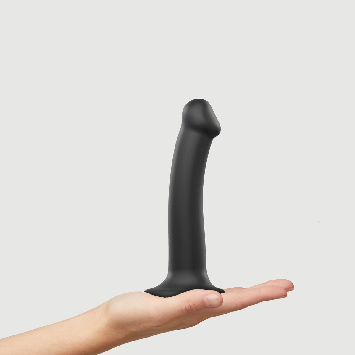 Strap On Me Dual Density Bendable Dildo, held in a hand for scale