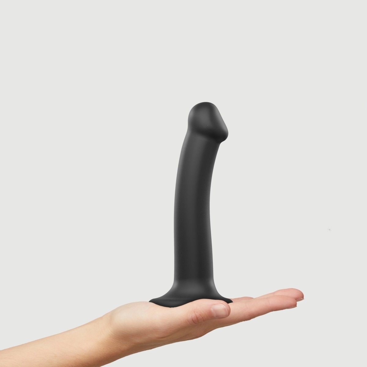 Strap On Me Dual Density Bendable Dildo, held in a hand for scale