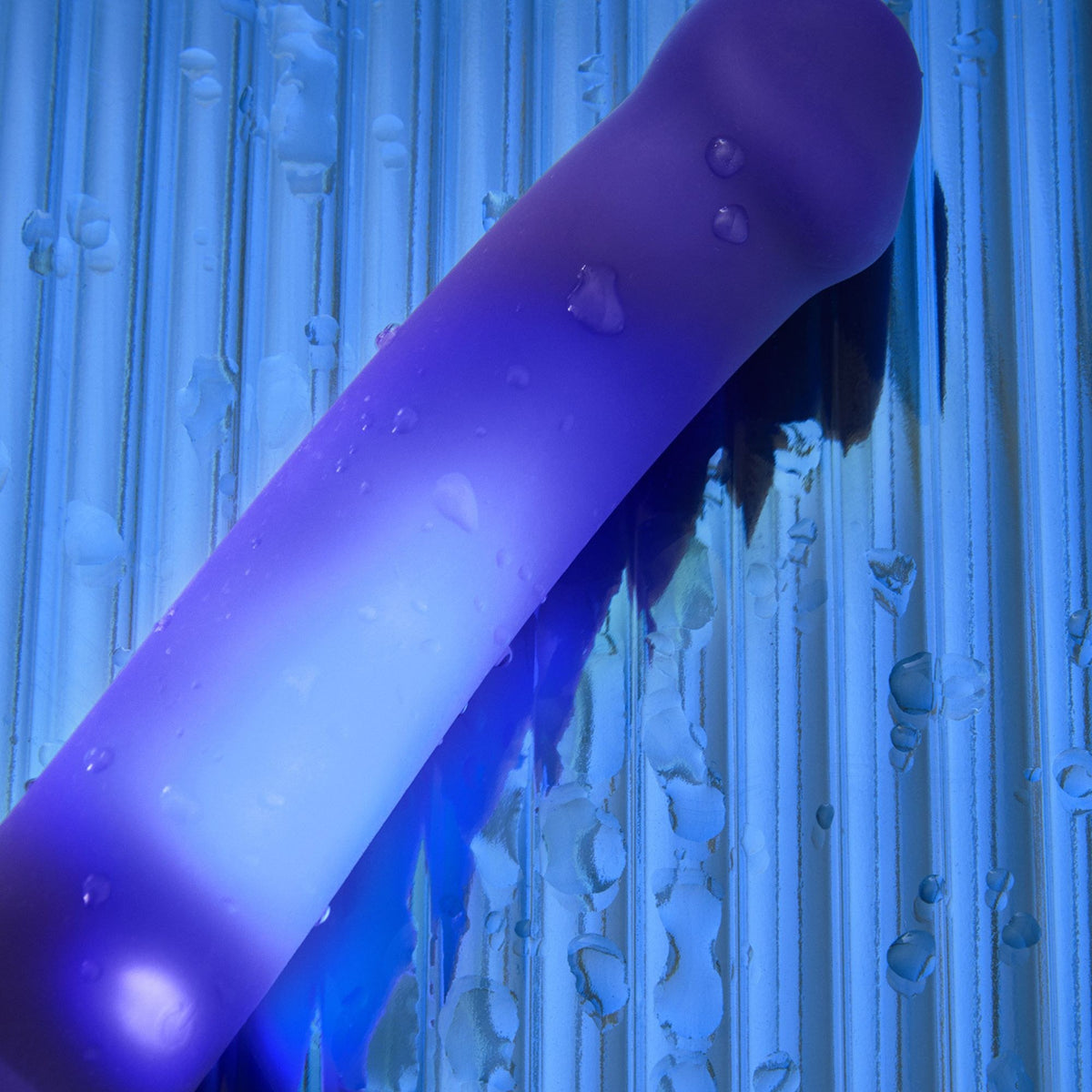 Strap On Me Glow LED Dildo in Purple, glowing in water