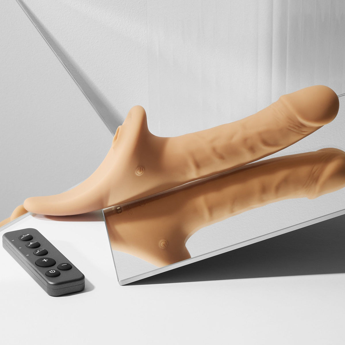 Strap On Me Multi Orgasm Realistic Vibrating Dildo in Vanilla, styled shot with remote