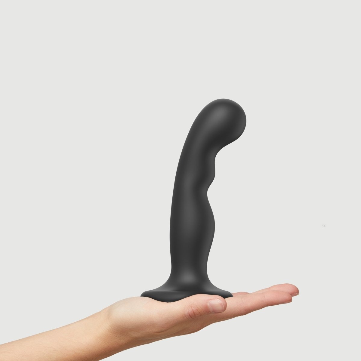 Strap On Me P&G Dildo Plug, standing on a hand