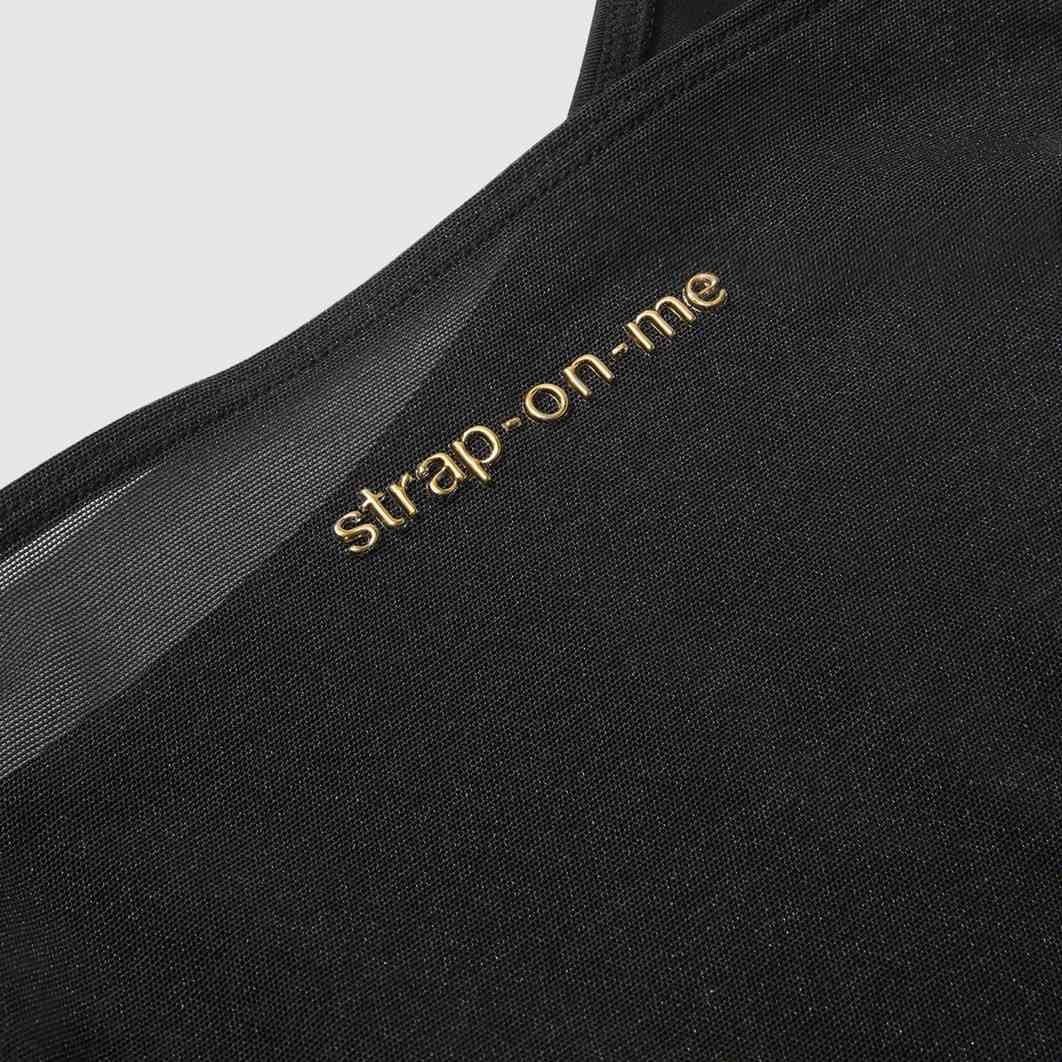 Strap On Me Signature Body Harness, embossed gold logo close-up