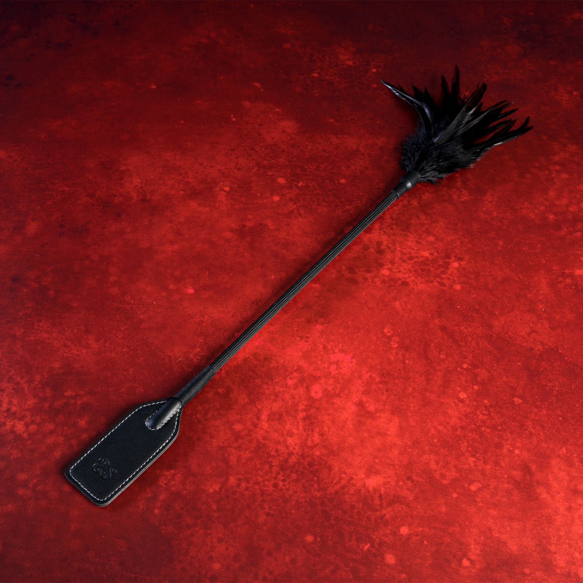 Sei Mio Slap and Tickle dual-ended crop with black feather tickler and faux leather slapper on red