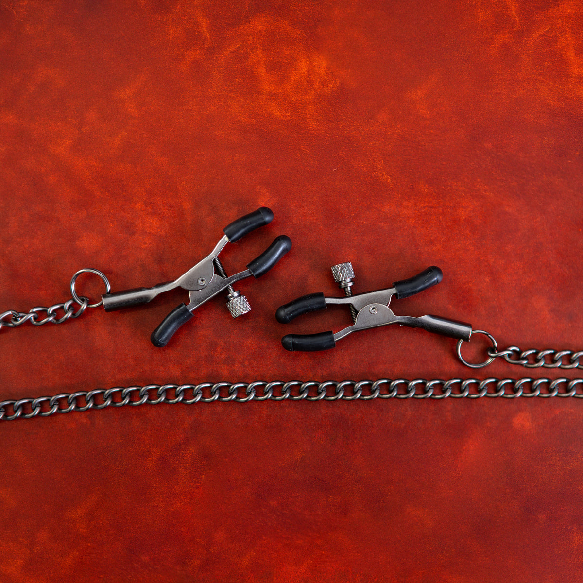 Sei Mio Nip and Tug adjustable nipple clamps with silicone tips and connecting chain on red