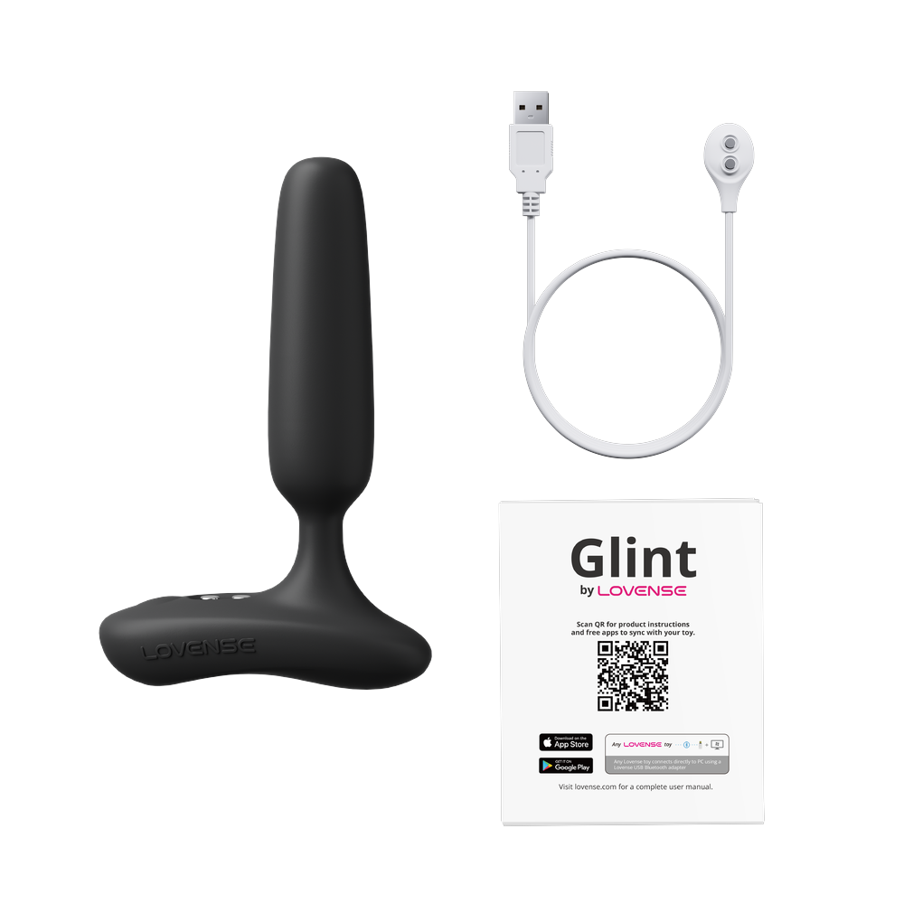 Lovense Glint box contents: black touch-responsive butt plug, magnetic USB charging cable and user manual
