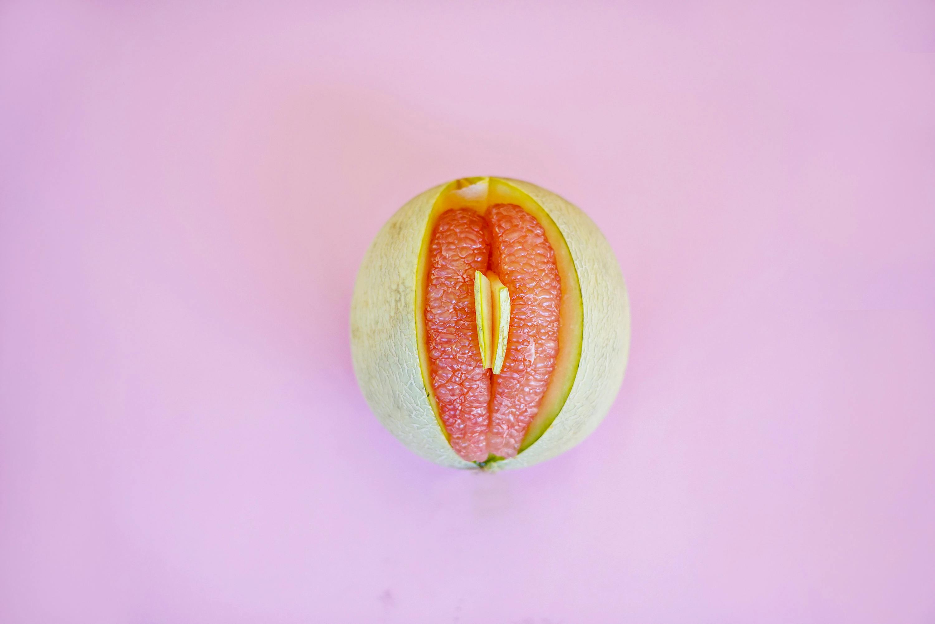 Halved melon on a pink background