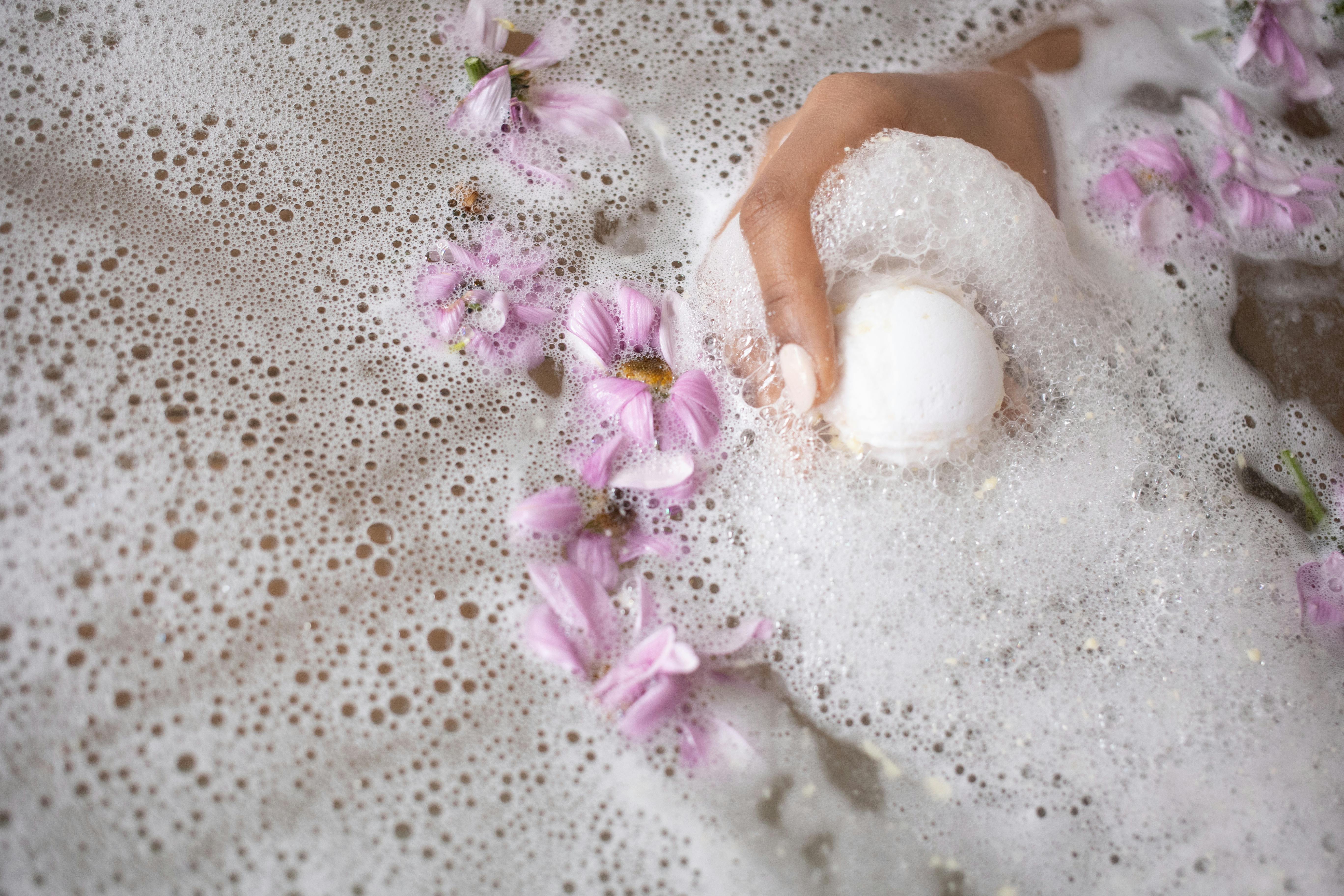 bath bomb with flowers in soapy water