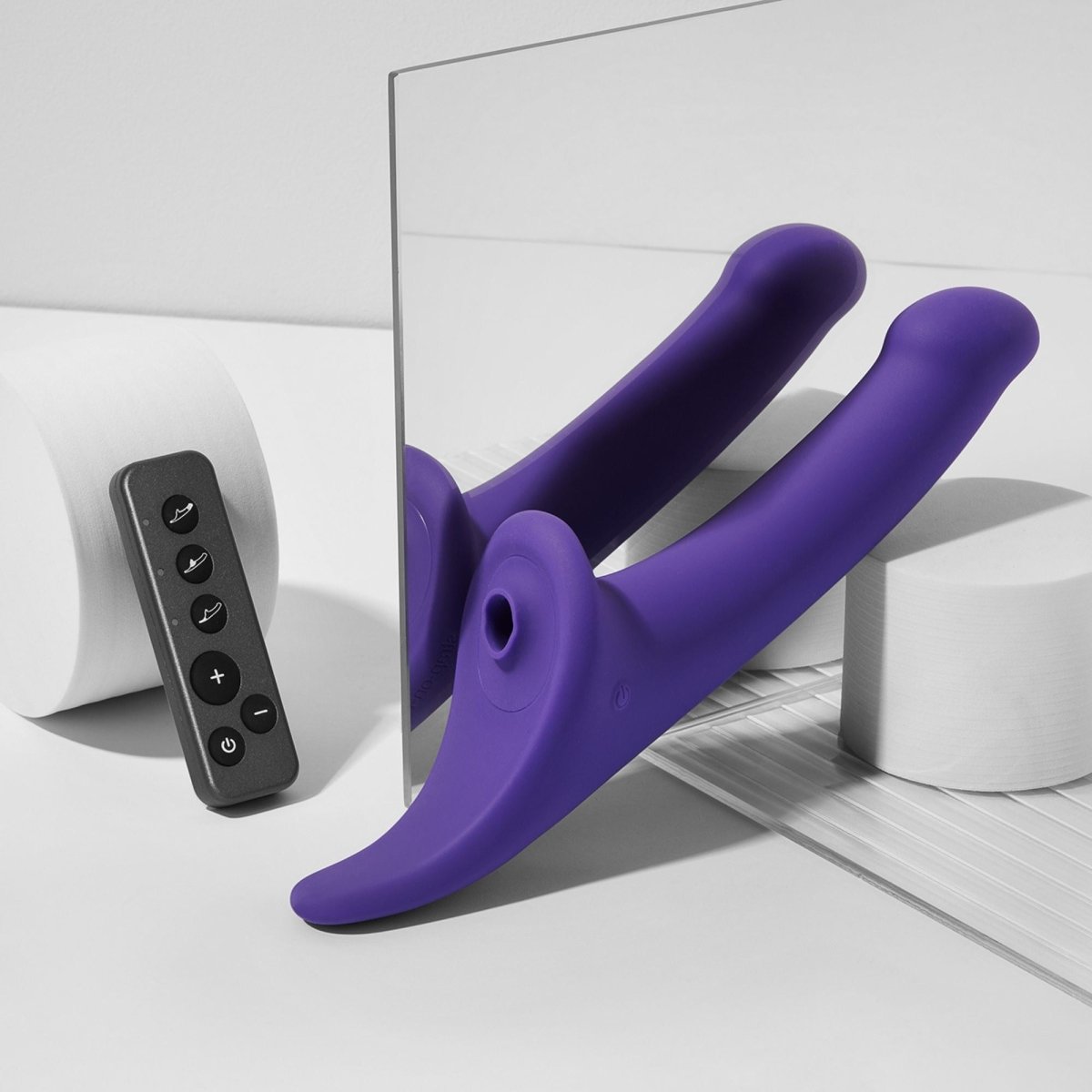 Strap On Me Multi Orgasm Vibrating Dildo in Purple, styled shot with remote