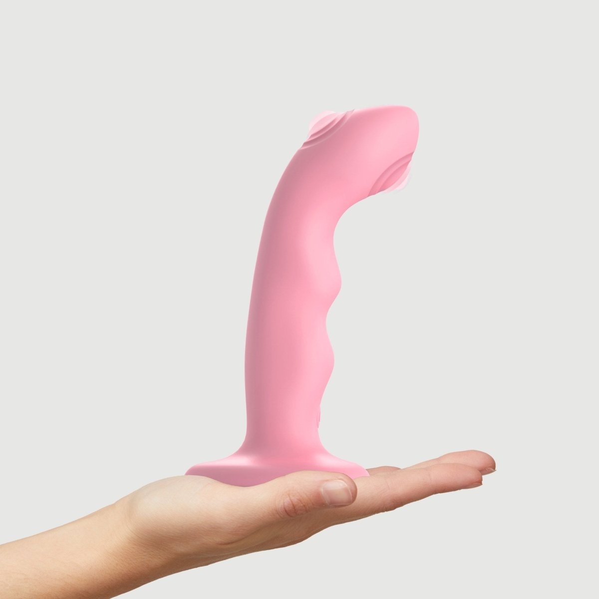 Strap On Me Tapping Dildo Wave in Pink, standing on a hand