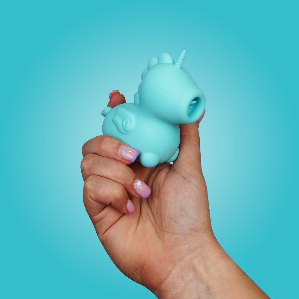 Hand holding the Unihorn Mount'n Peak clitoral vibrator